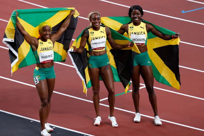 Jamaica’s Shelly-Ann Fraser-Pryce, Elaine Thompson-Herah and Shericka Jackson hold up the...