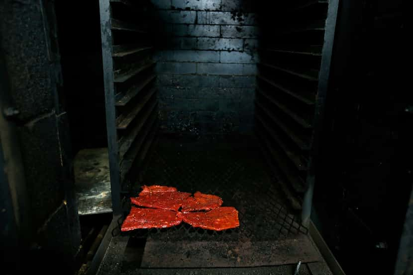 Owner Shawn Knowles smokes meat in the pits while he shows how to make jerky at his store...