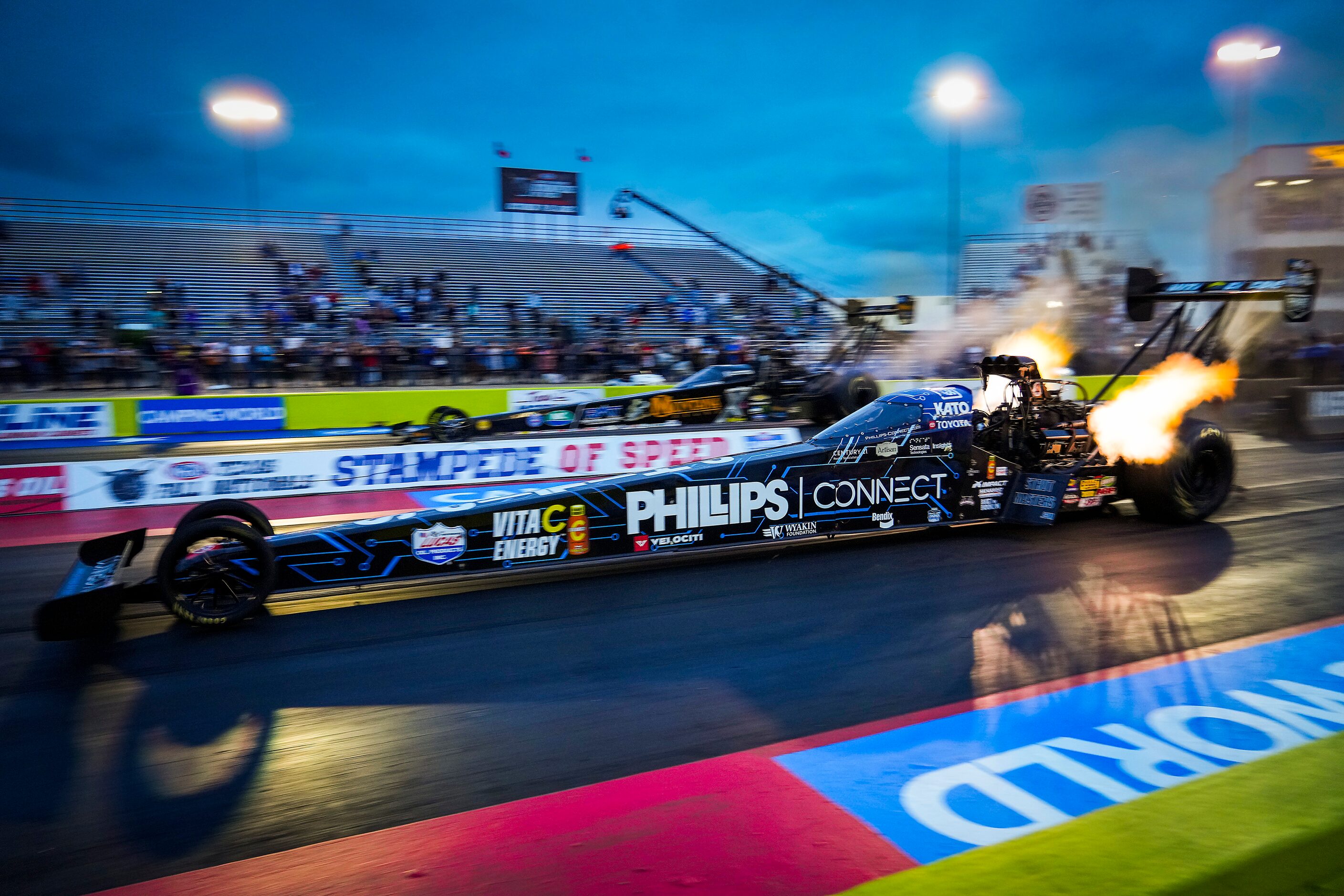 Justin Ashley comes off the line crew at the start of his Top Fuel  over Austin Prock (top)...