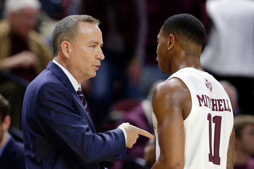 Texas A&M head coach Billy Kennedy talks with guard Wendell Mitchell (11) between plays...