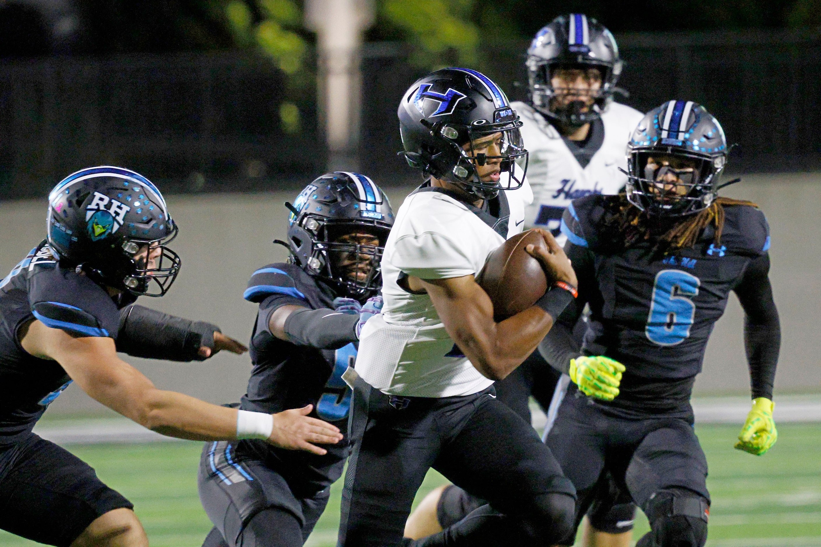 Hebron's quarterback Patrick Crayton Jr. (10) carries the ball against Rock Hill players in...