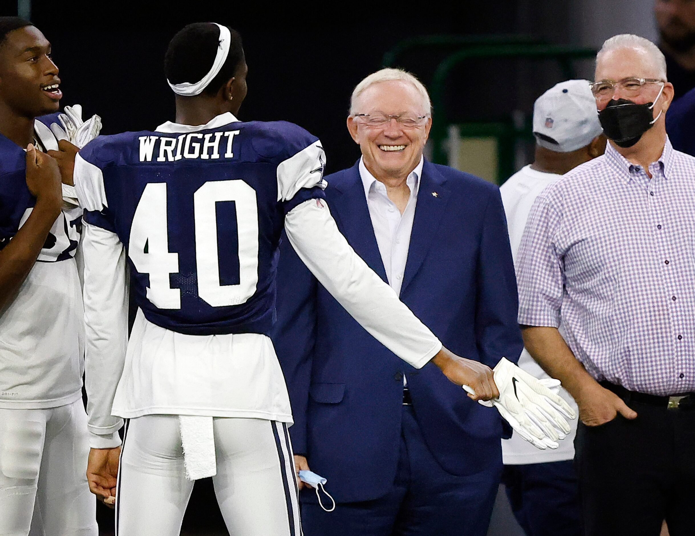 Dallas Cowboys cornerback Nahshon Wright (40) says something to make owner Jerry Jones crack...