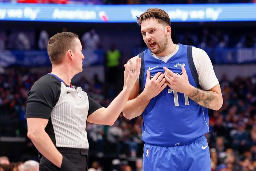Dallas Mavericks guard Luka Doncic (77) talks with a referee during the first half of an NBA...