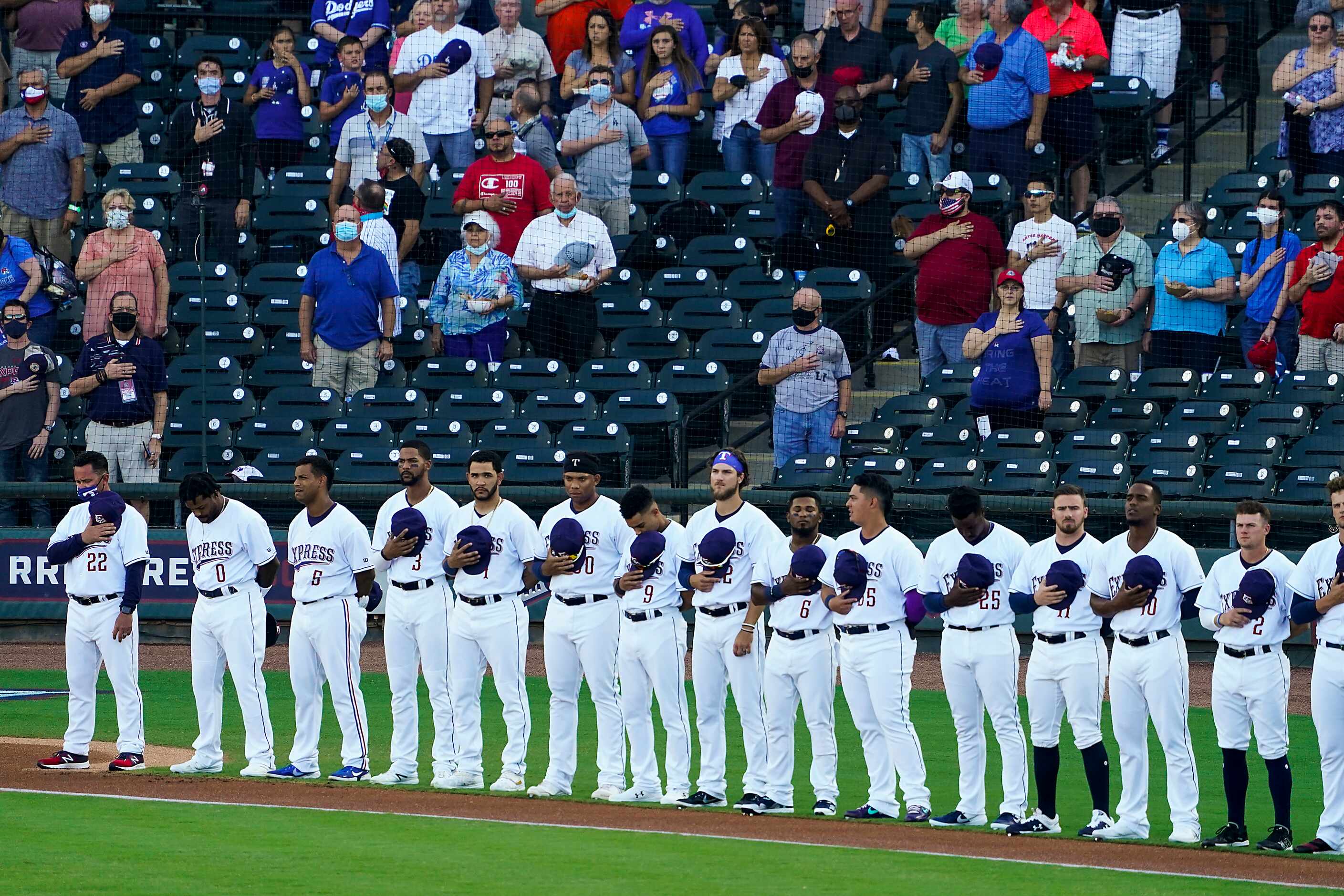 Round Rock Express players stand for the national anthem at Dell Diamond before the season...