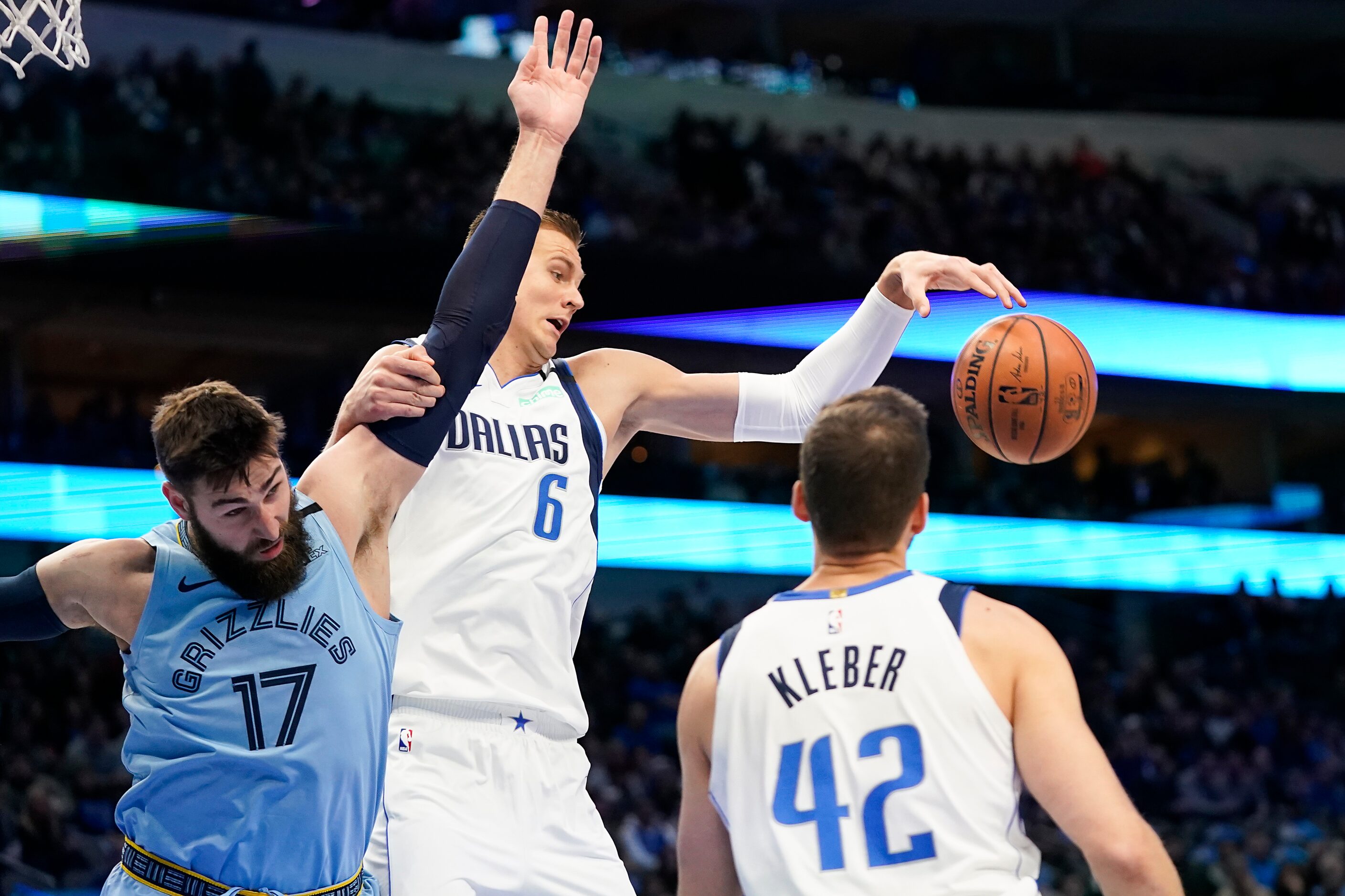 Dallas Mavericks forward Kristaps Porzingis (6) grabs a rebound away from Memphis Grizzlies...