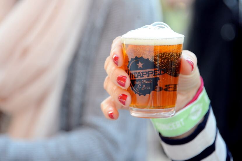 Lagunitas Brewing Company serves beer to a guest at Untapped Music and Beer Festival at...