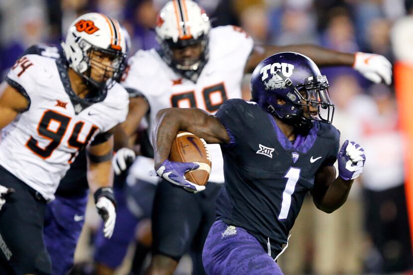 FILE - TCU Horned Frogs wide receiver Jalen Reagor (1) races around the end for a long third...