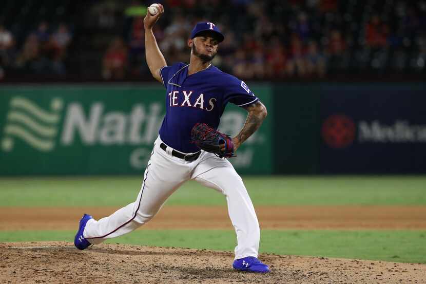 ARLINGTON, TEXAS - AUGUST 21:  Jonathan Hernandez #72 of the Texas Rangers throws against...
