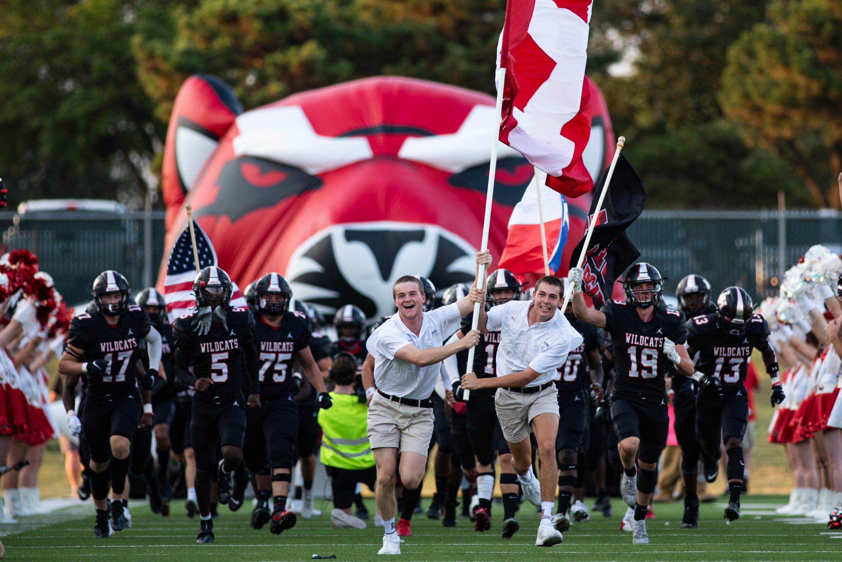 The Lake Highlands Wildcats rush onto the field prior to the start of their home game...