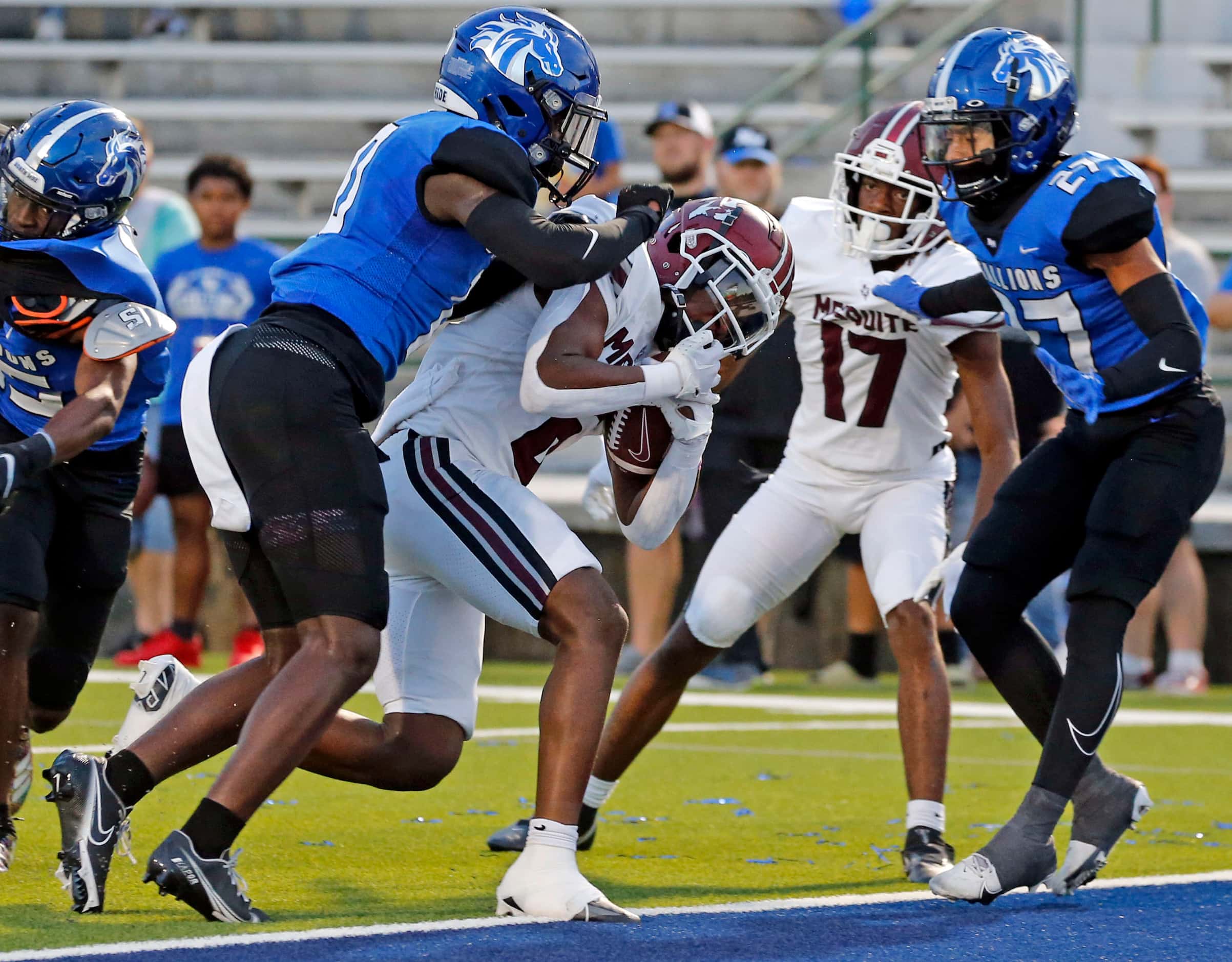 Mesquite High’s Armand Cleaver (6) scores a touchdown in a crowd during the first half of a...