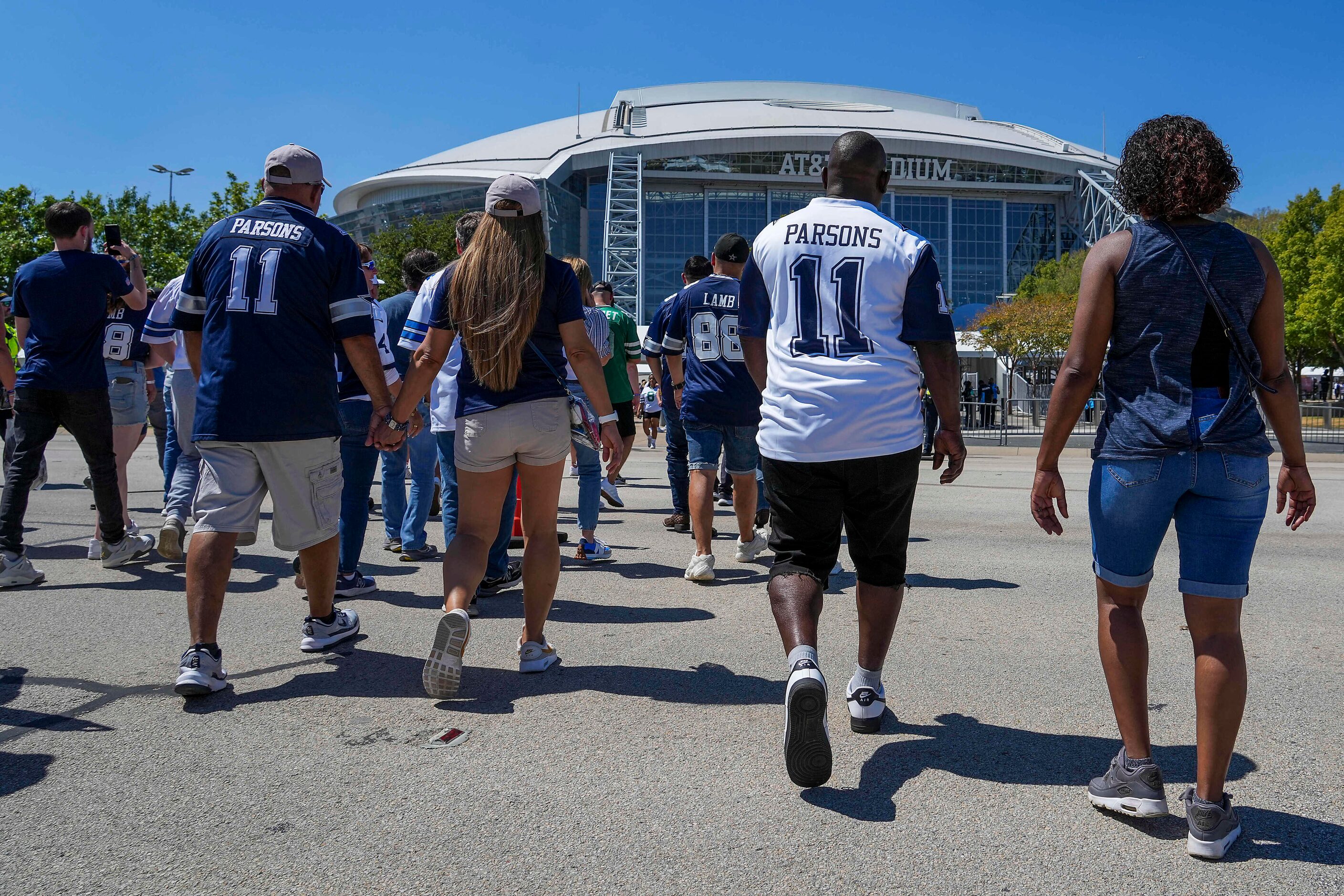 Dallas Cowboys fans head to the stadium before an NFL football game at AT&T Stadium against...