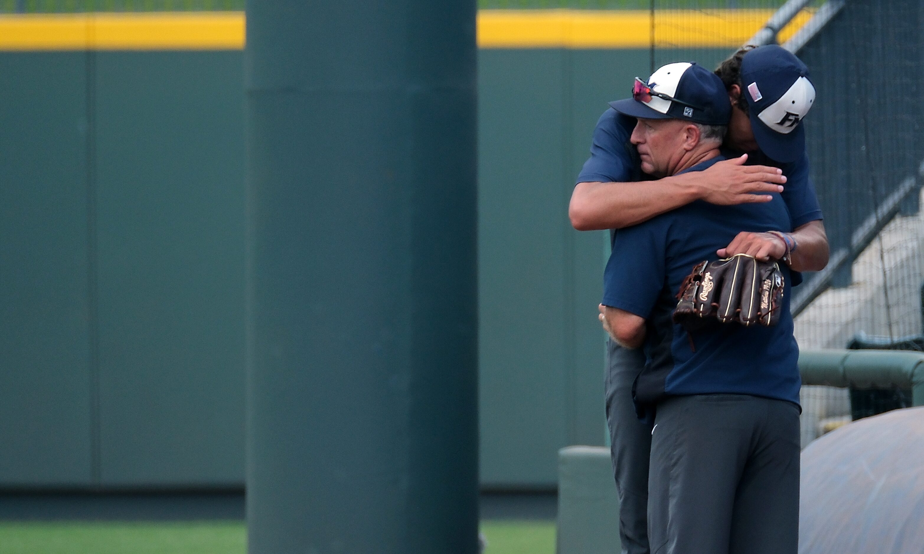 Flower Mound coach, Danny Wallace, hugs Jacob Gholston, (11), before the start of action...