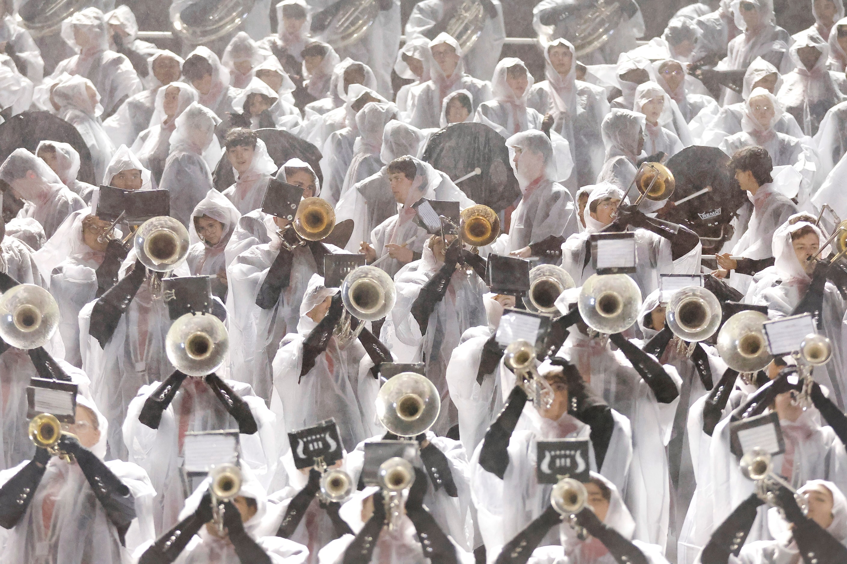 With a heavy mist raining down, the Arlington Martin band performs in their rain coats...