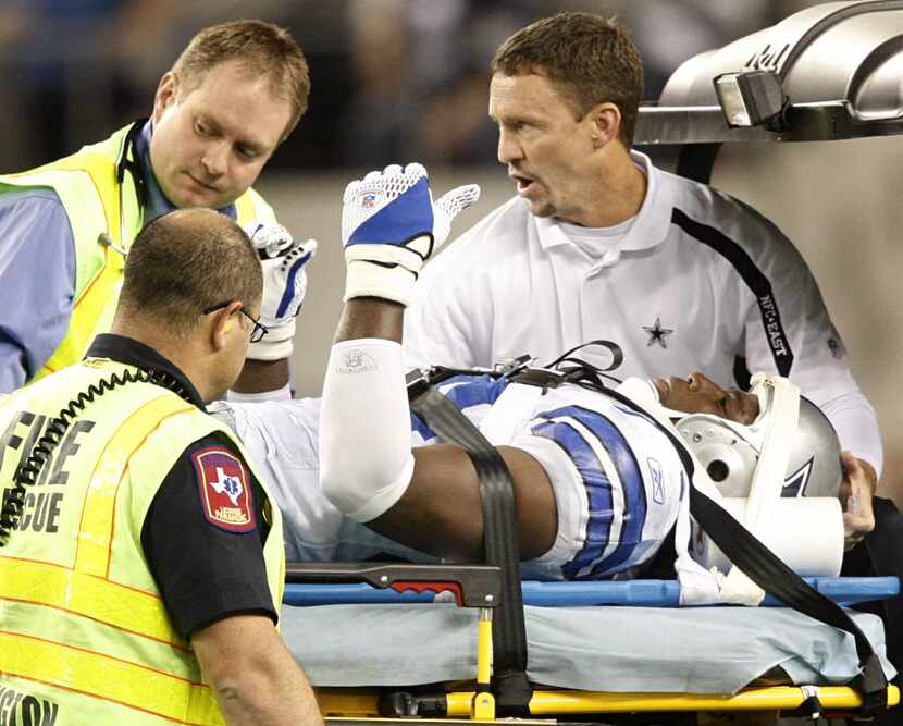 Dallas Cowboys linebacker DeMarcus Ware gives the thumbs up to the fans as he is driven off...