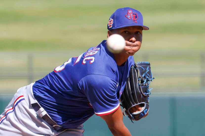 Texas Rangers Jose Leclerc throws during the third inning of a spring training game against...