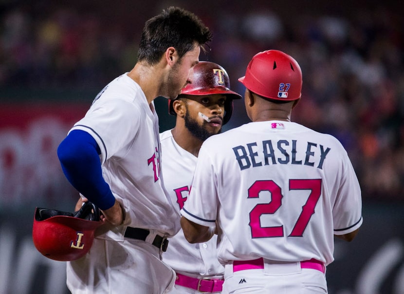 Texas Rangers third baseman Joey Gallo (13) and left fielder Delino DeShields (3) talk to...