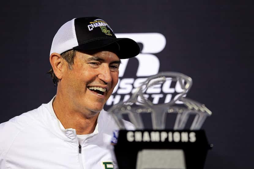Art Briles stands next to the Russell Athletic Bowl Trophy after his team's win over North...