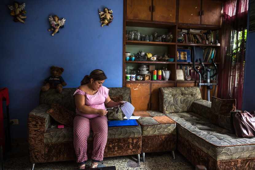 Margarita Rosa Barrios reads paperwork at her parents' home in Cucuta, Colombia, on Feb. 5....