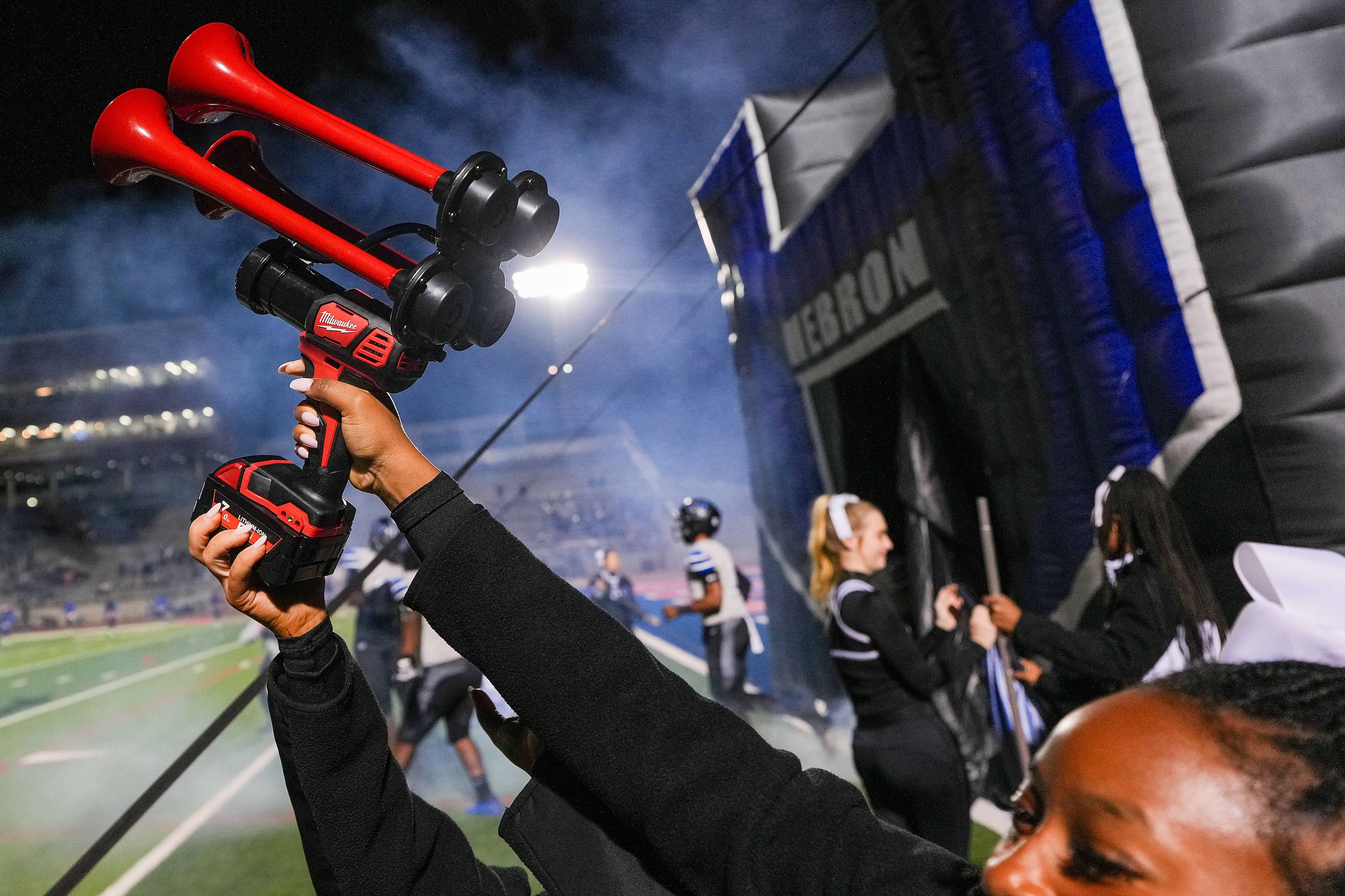 Hebron cheerleaders blown an airhorn as the team takes the field for the first half of a...