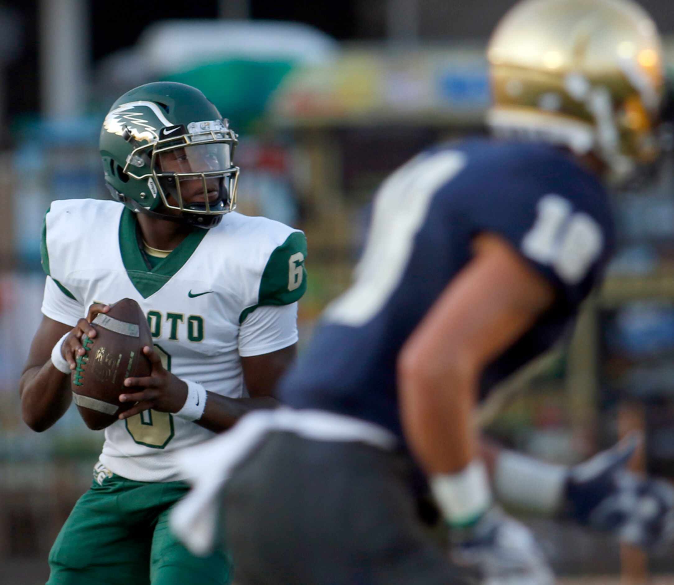 DeSoto quarterback Samari Collier (6) drops back in search of an open receiver during first...