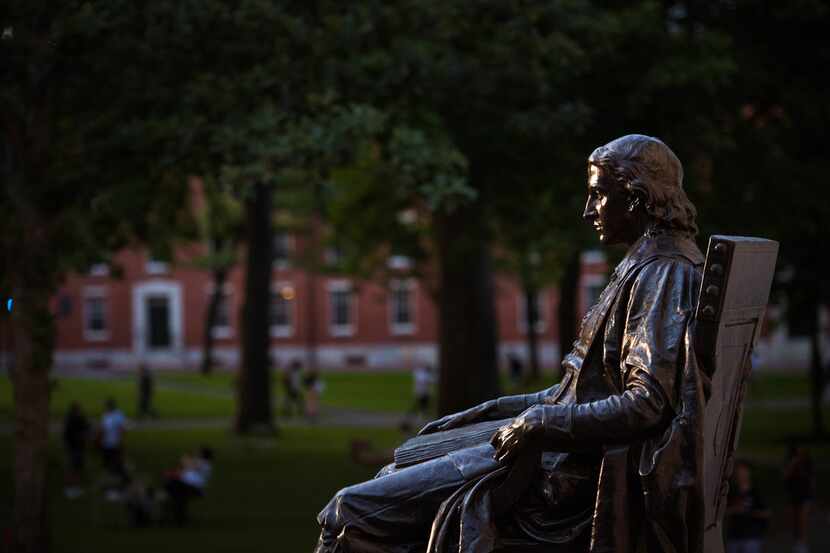 A statue of John Harvard on Harvard University's campus in Cambridge, Mass., July 12, 2018....
