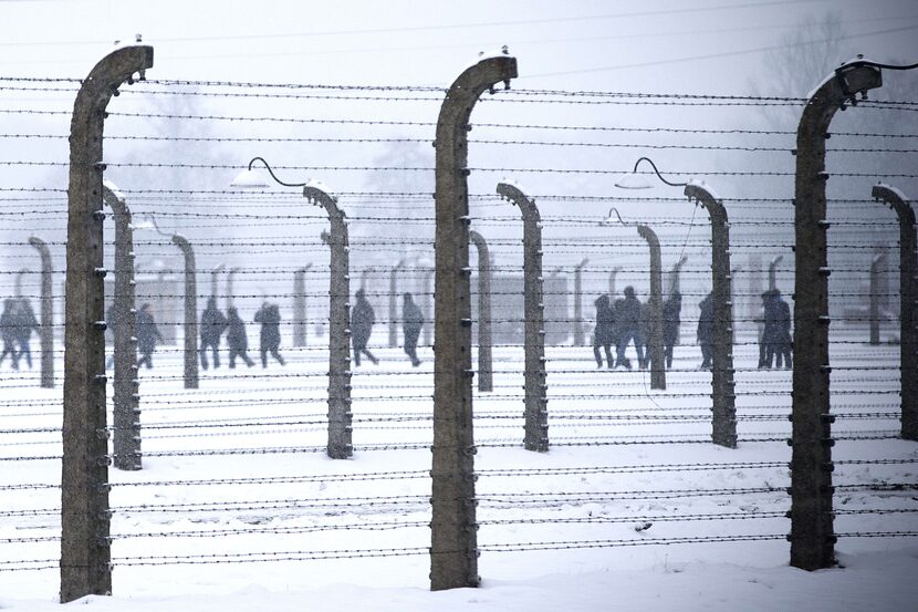 Visitors walk inside the former Nazi concentration camp Auschwitz-Birkenau in Poland....