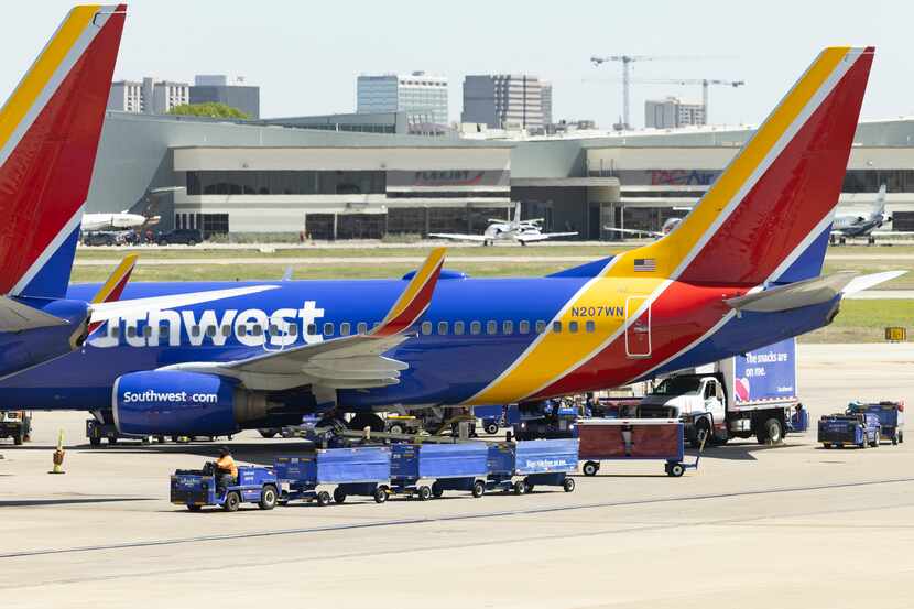 Southwest Airlines planes are preparing for their next flights on the tarmac at Dallas Love...