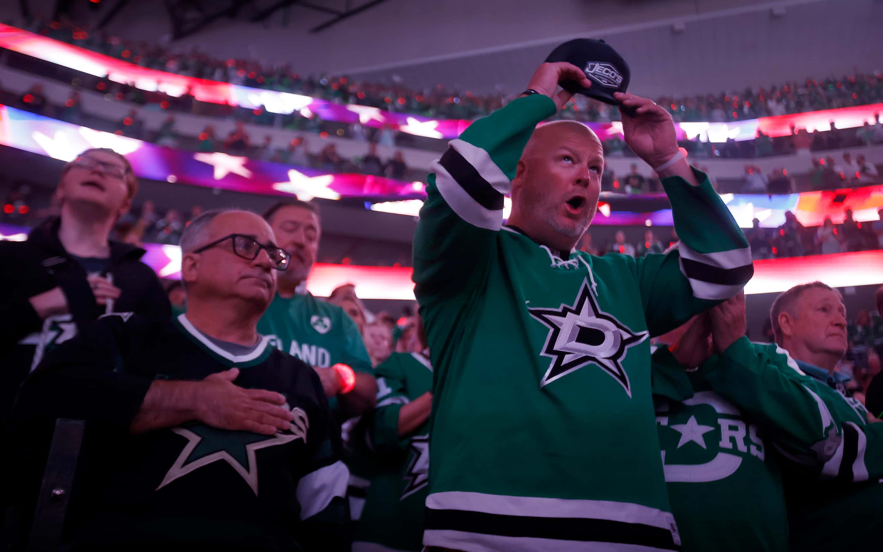 Dallas Stars fans cheer following the national anthem before Game 4 of a first round Stanley...