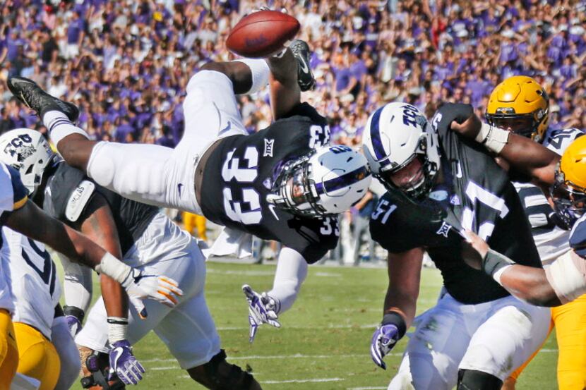 TCU Horned Frogs running back Sewo Olonilua (33) goes airborne to score a second-quarter...