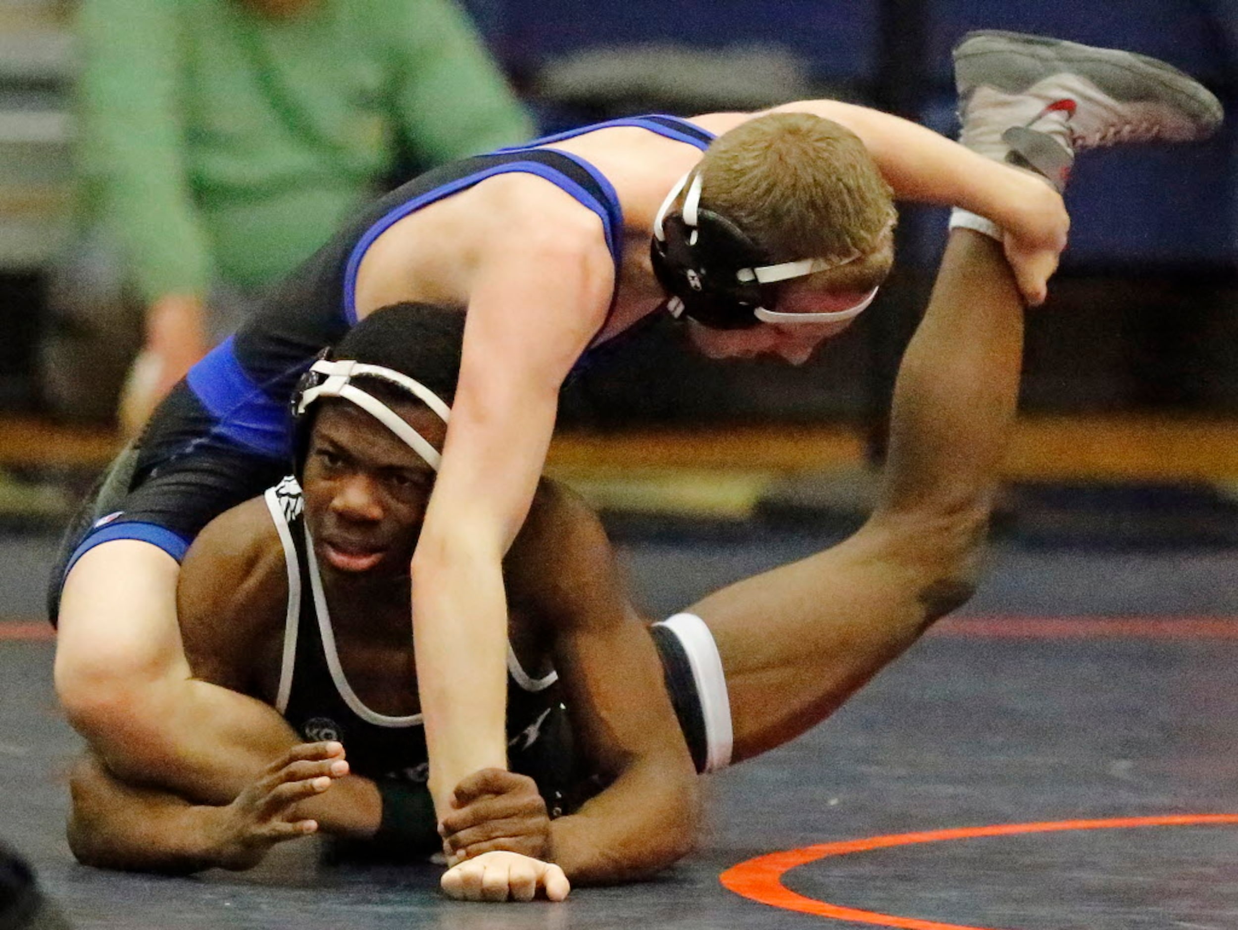 Precious Essien (top) of Frisco Liberty, competes with Jackson Carter of Midlothian in the...