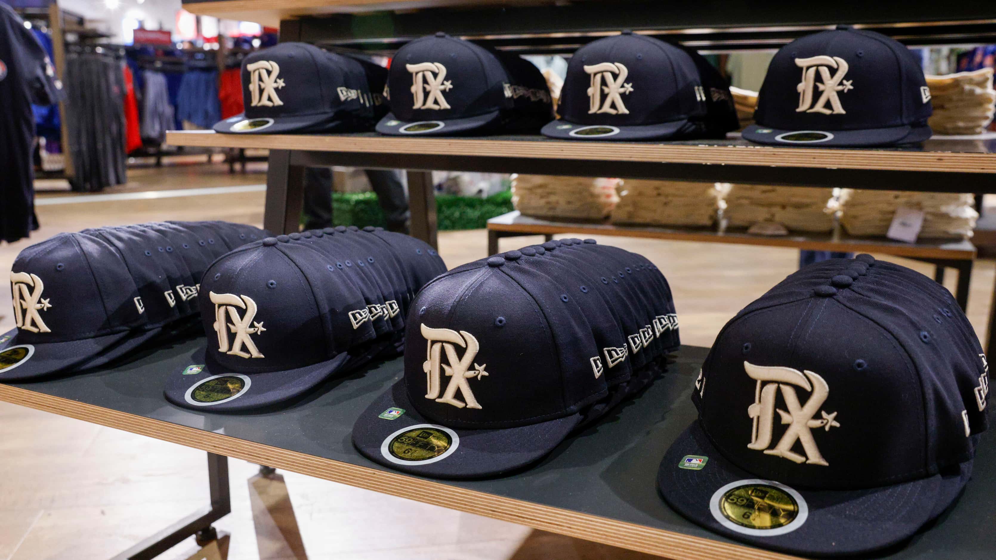 New Texas Rangers City Connect Jersey hats sit for sale on a shelf at Globe Life Field on...