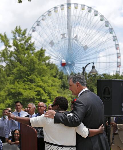 Dallas Mayor Mike Rawlings (right) and the Dallas City Council's Carolyn R. Davis join...