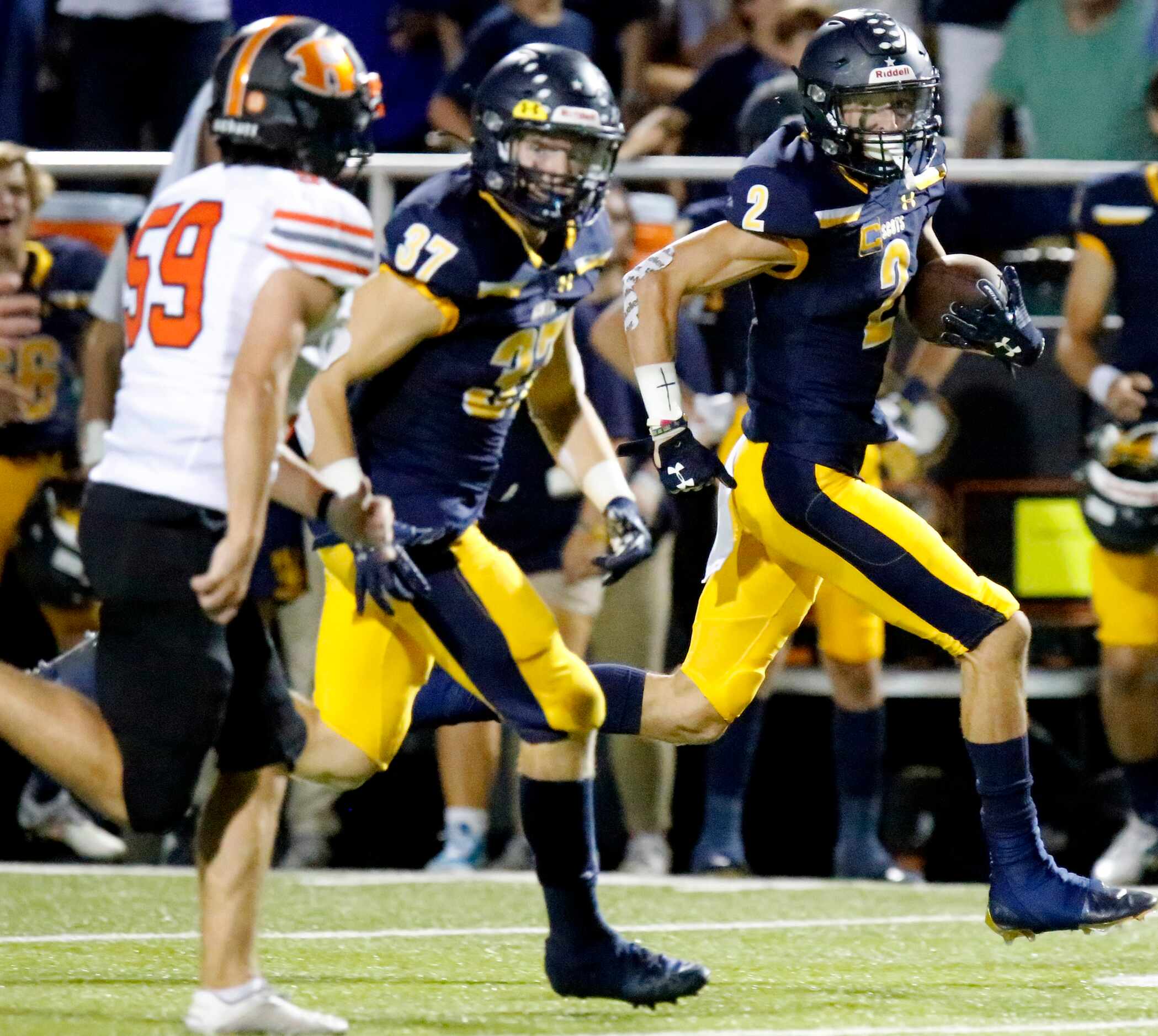 Highland Park High School wide receiver John Rutledge (2) returns a kickoff for a touchdown...