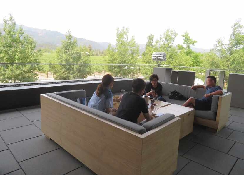 Visitors to Hall Wines in St. Helena, Calif., enjoy the view of the Mayacamas Mountains from...