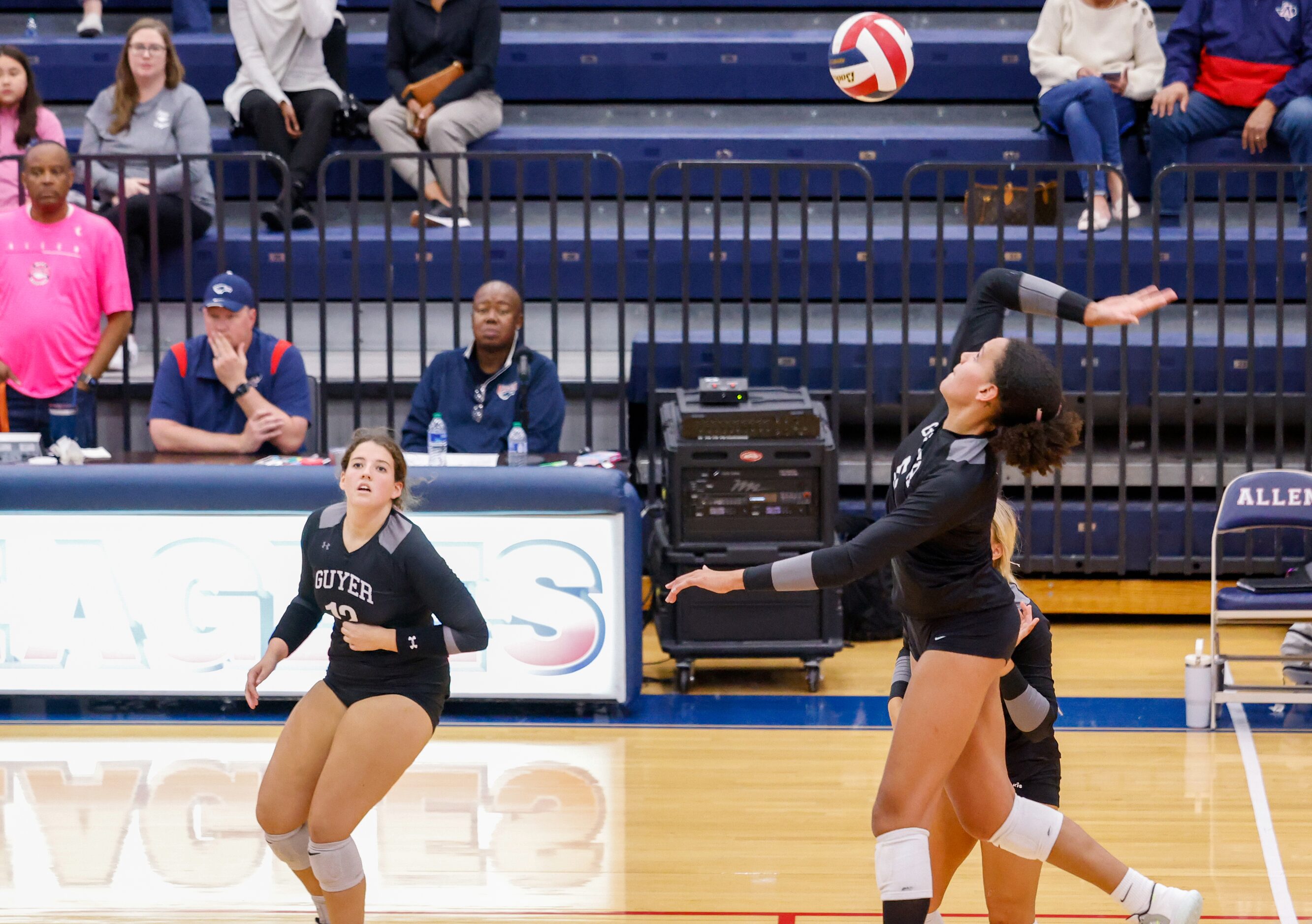 Denton Guyer senior Kyndal Stowers (5) leaps in preparation for spiking the ball during a...