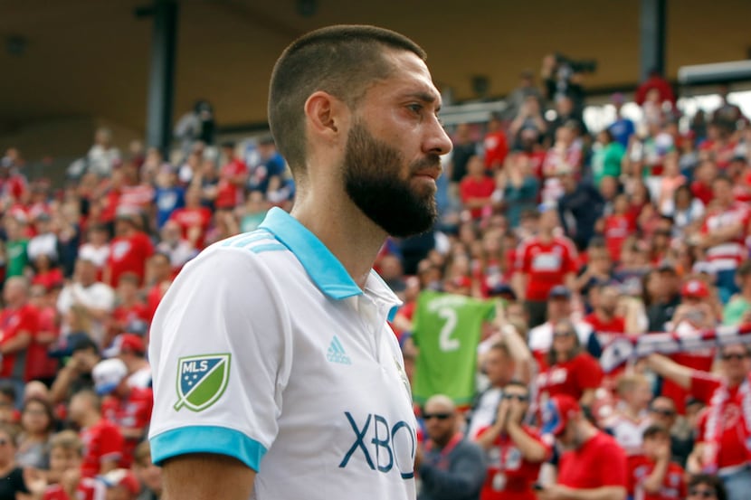 Seattle Sounders Clint Dempsey (2) receives a warm FC Dallas exit greeting after he received...