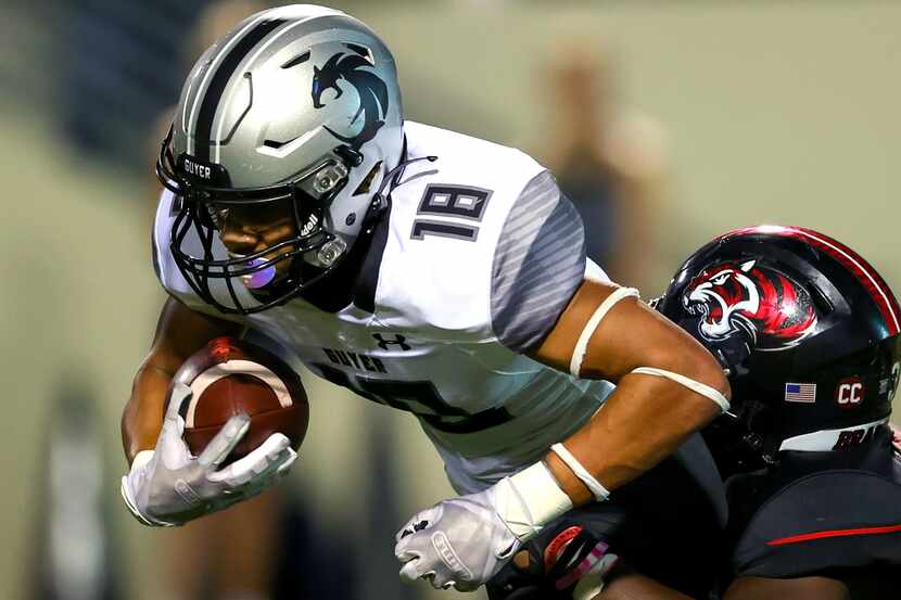 Denton Guyer kick returner Eli Bowen (18) is tackled by Denton Braswell linebacker Alan...