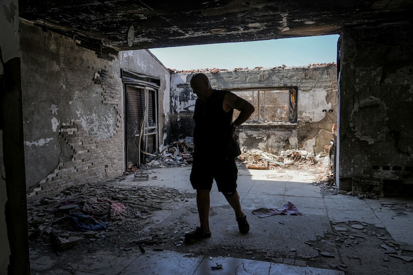 Meir Zarbiv, a member of Kibbutz Be'eri, an Israeli communal farm, visits a battle-scarred...