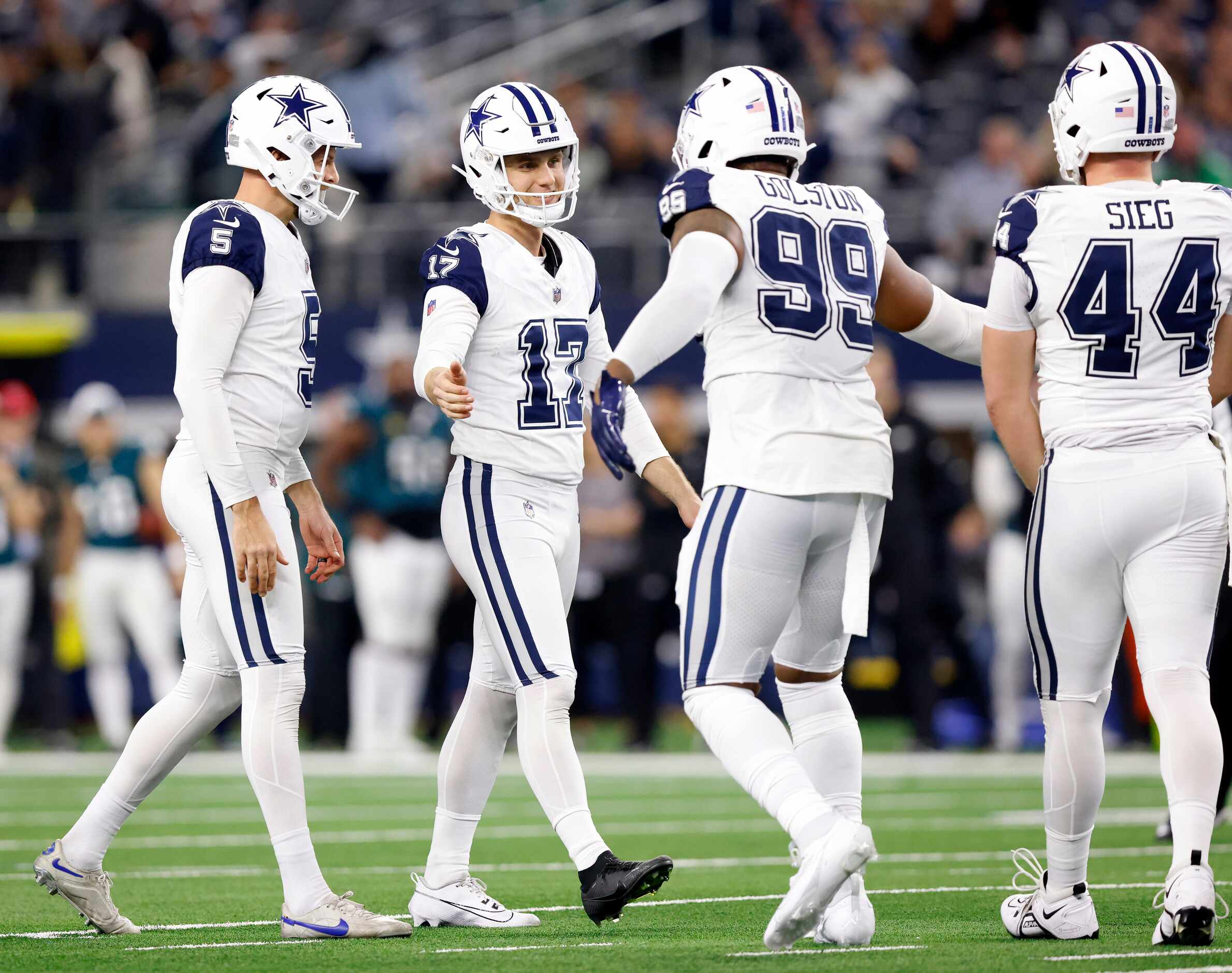 Dallas Cowboys place kicker Brandon Aubrey (17) is congratulated on his late fourth quarter...