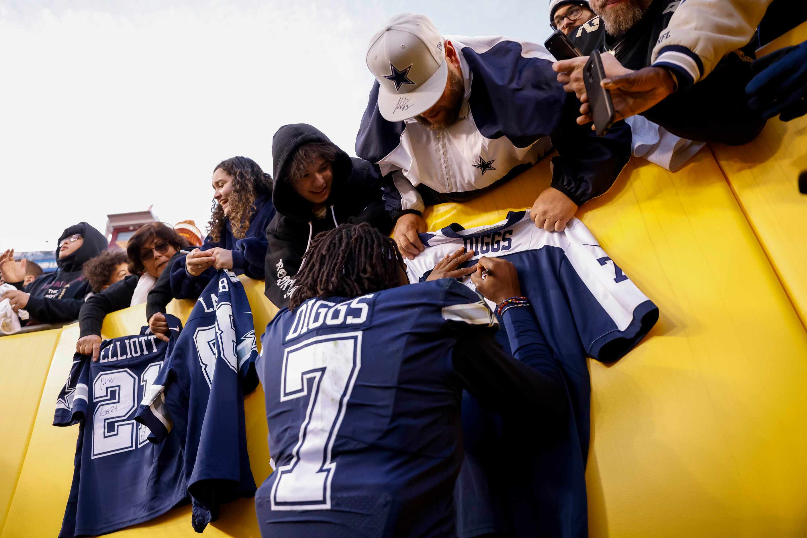Dallas Cowboys cornerback Trevon Diggs (7) signs jerseys after winning against the...