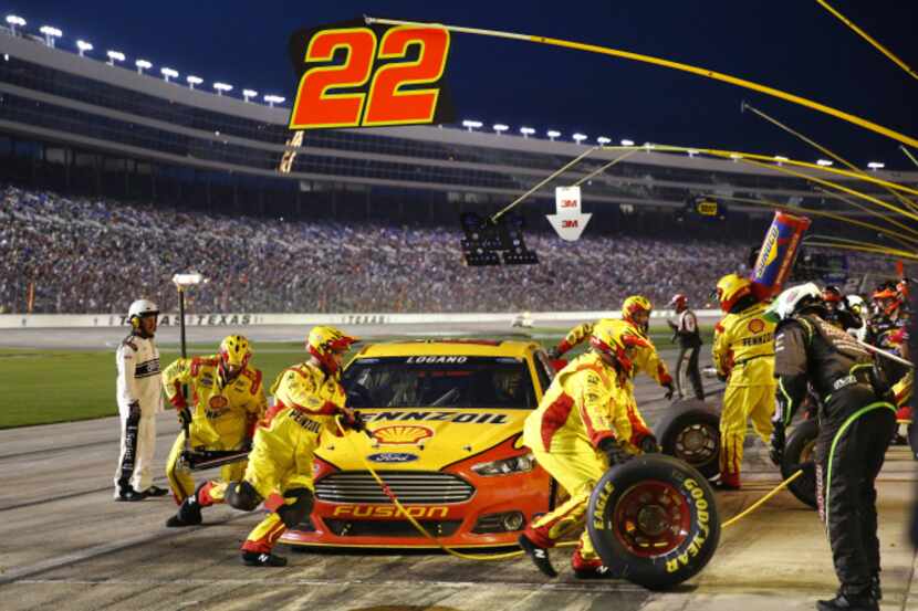 NASCAR Sprint Cup Series driver Joey Logano receives a four tire change on his Shell...