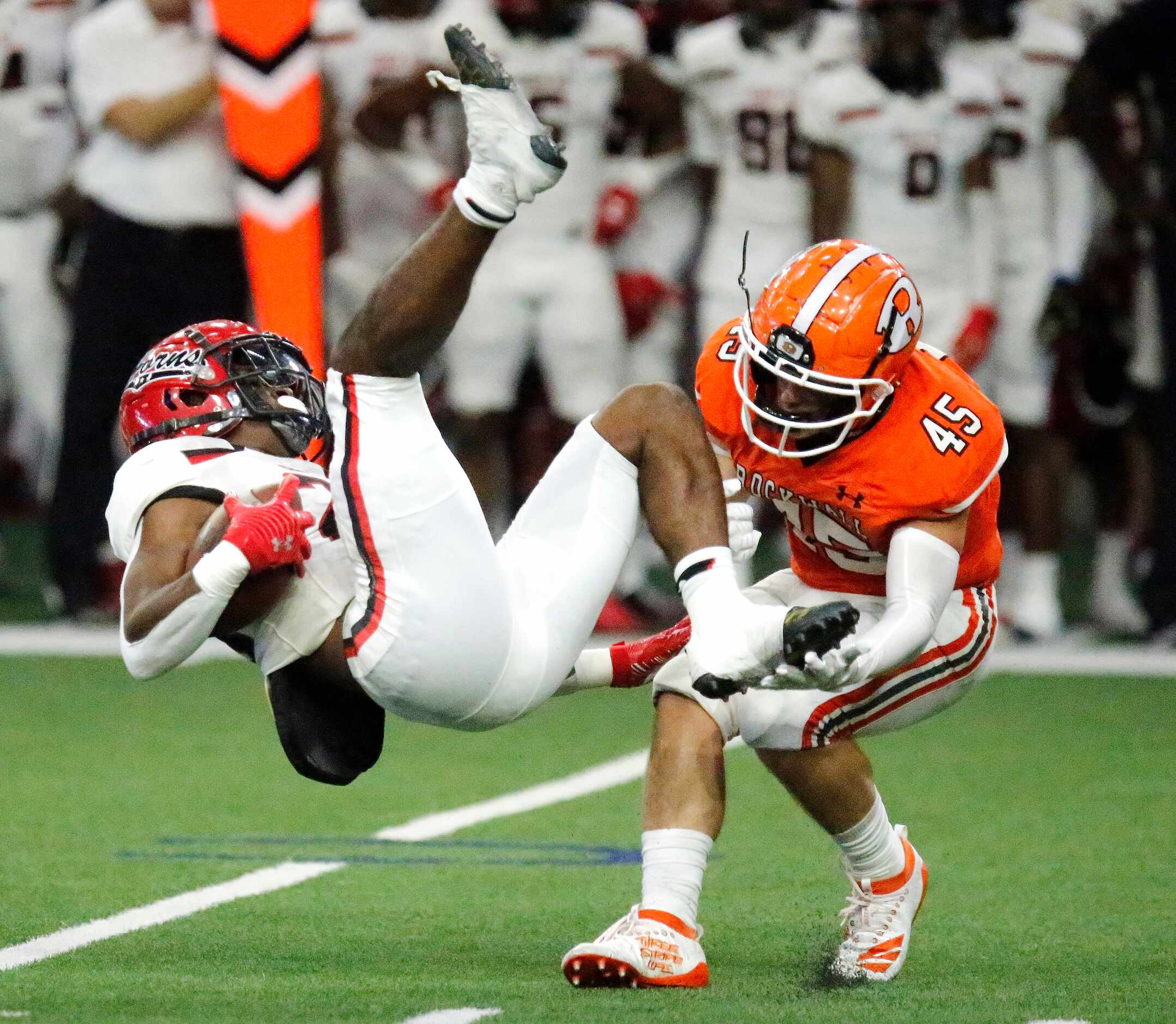 Cedar Hill running back Tristan Bell (26) is upended by Rockwall High School linebacker...