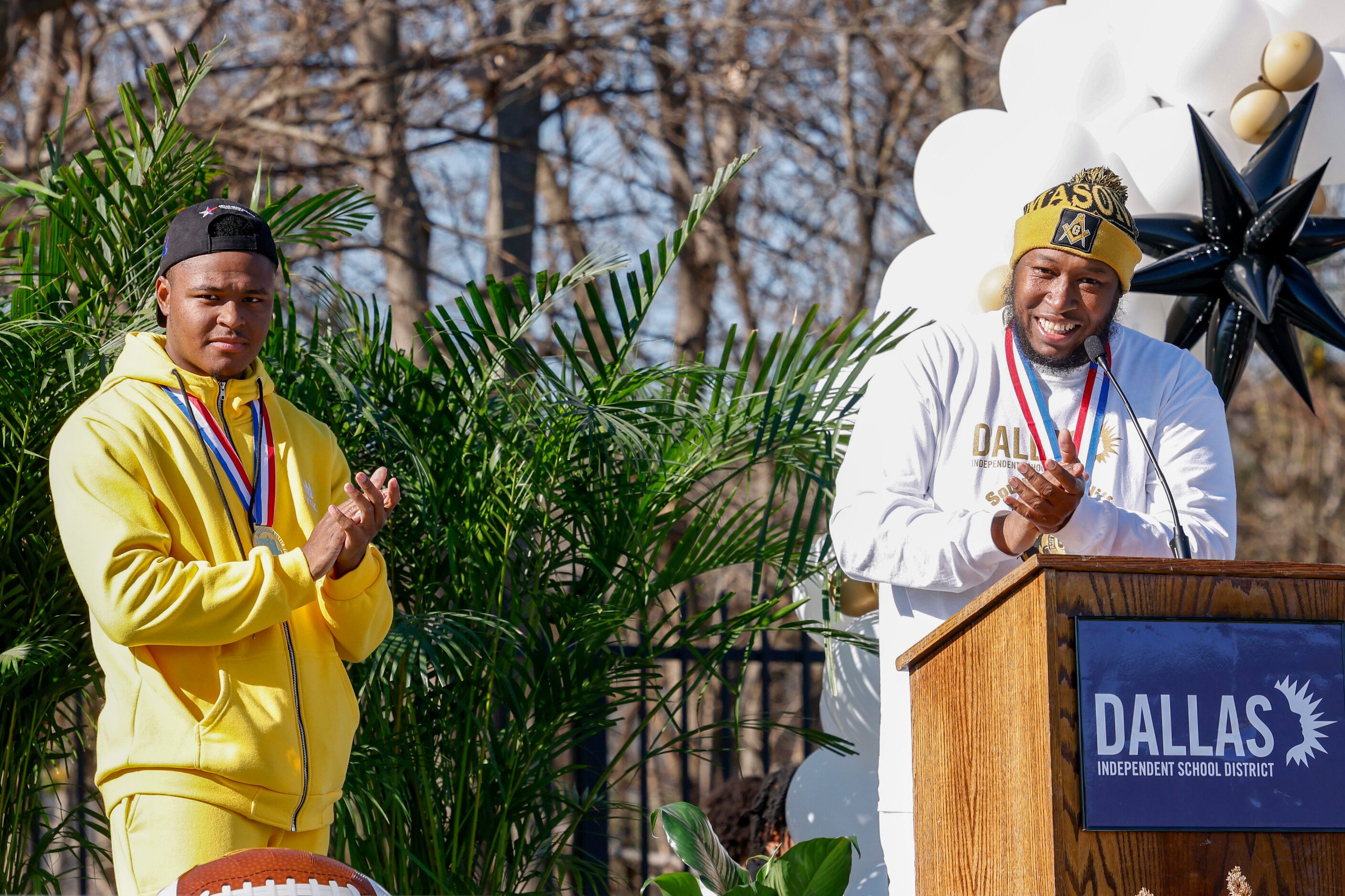 Dallas ISD trustee Maxie Johnson speaks alongside his son David during a celebration for...