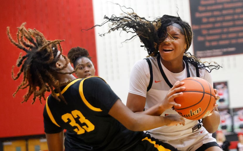 Frisco Liberty’s Jacy Abii (3) drives into Frisco Memorial’s Jevan Collier (33) during a...