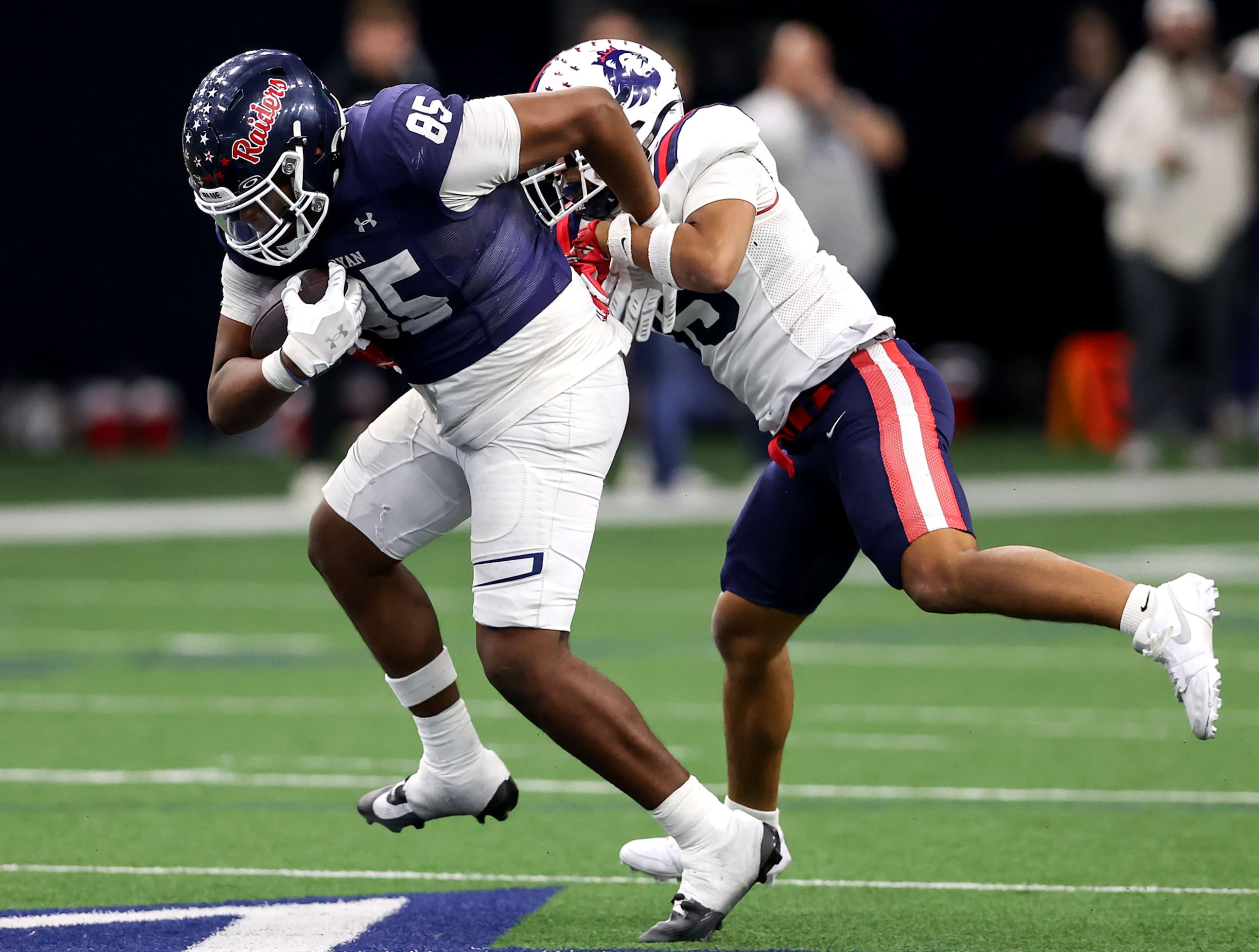 Denton Ryan half back Joses Melendez (85) tries to elude Richland defensive back Sean Wright...