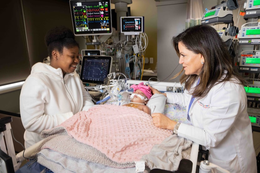 Brianna Hogg looks at four-month-old daughter Ja’khaia Williams while talking to Dr....