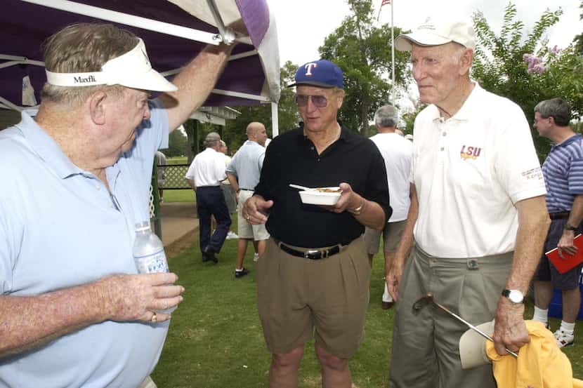 Louisiana Sports Hall of Fame inductees Jim Cason, left, and Mel Didier, center, talk with...