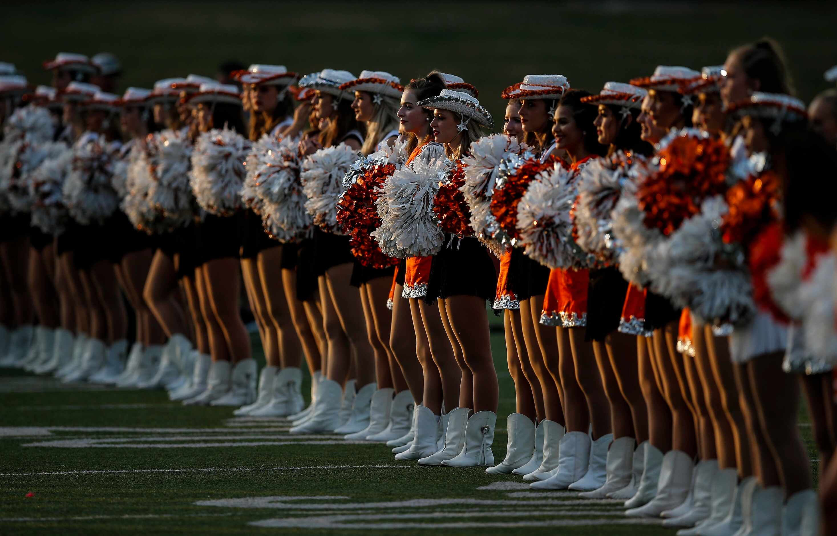 The Rockwall Stingerettes perform before the first half of a high school football game...
