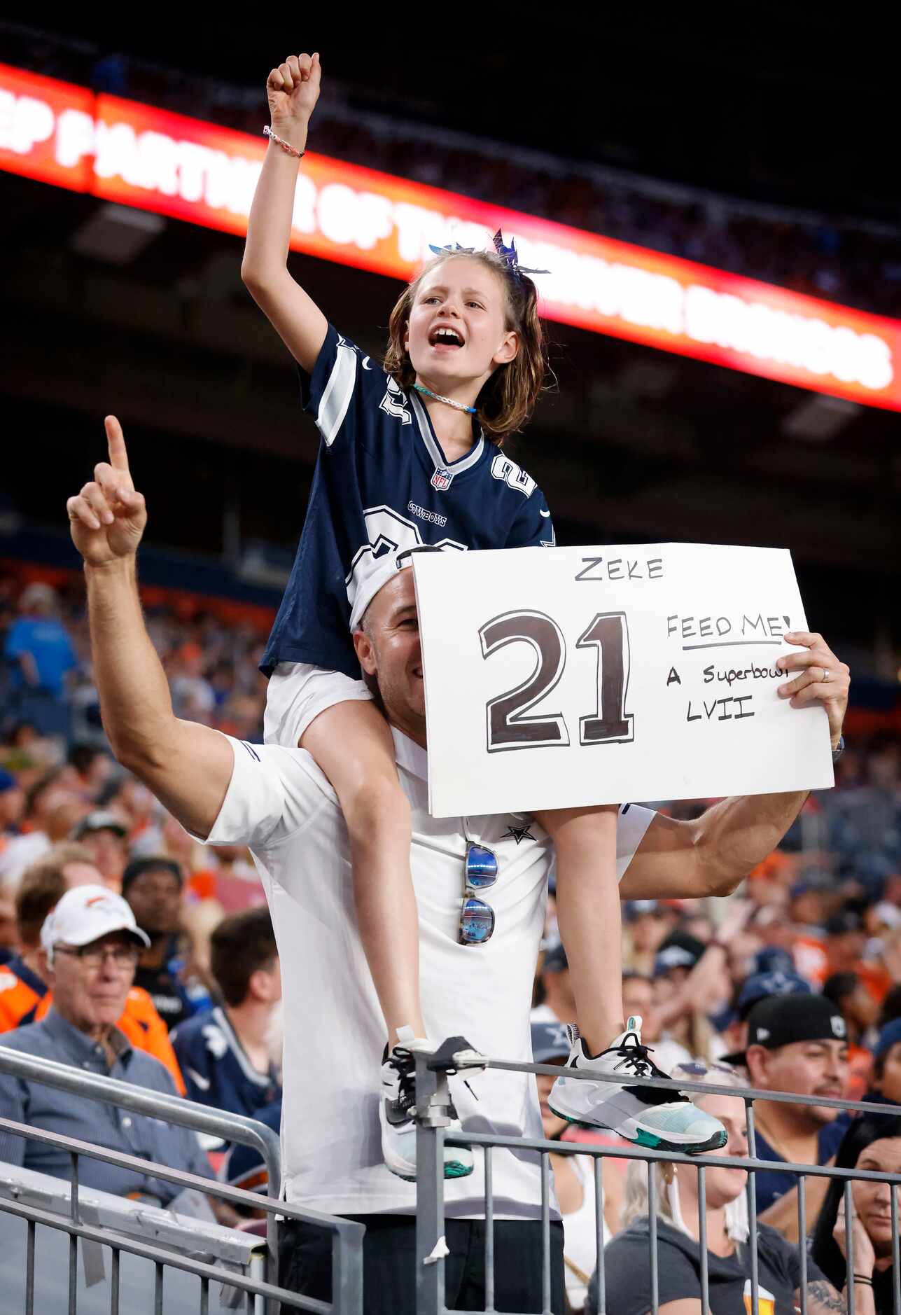 Dallas Cowboys fans Cher their team as they face the Denver Broncos during the first half at...