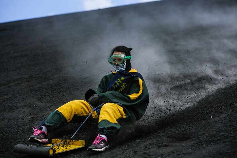 A tourist careens down Cerro Negro. Volcano boarders can reach speeds of 40 mph or more. 